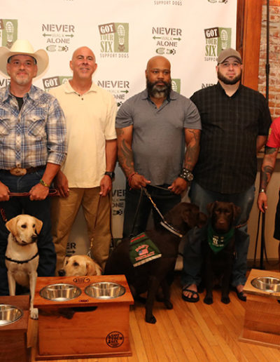 Group of veterans and their service dogs at the Got Your Six Support Dogs graduation ceremony
