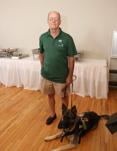 Veteran with his german shepard service dog at Got Your Six Support Dogs graduation ceremony