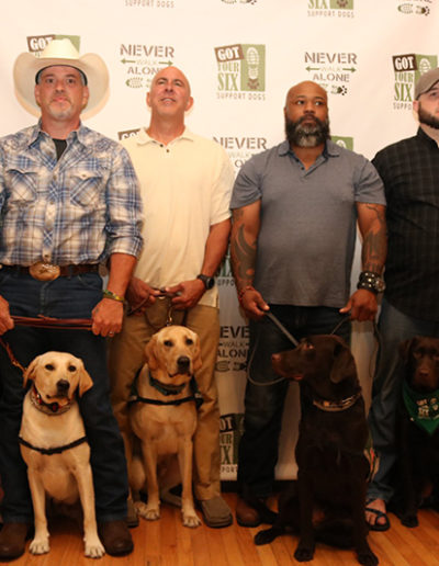 Group of veterans receiving their service dogs at Got Your Six Support Dogs graduation ceremony