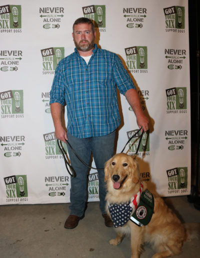 Veteran with golden retriever service dog at Got Your Six Support Dogs graduation ceremony