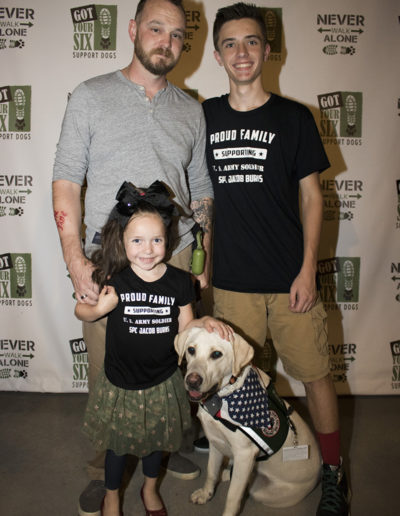 Veteran with son and daughter and white lab service dog at Got Your Six Support Dogs graduation ceremony