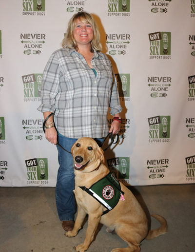 Woman veteran and lab service dog at Got Your Six Support Dogs graduation ceremony