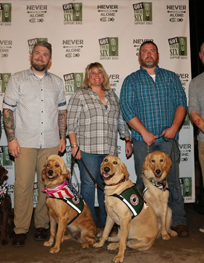 Group of veterans with their service dogs at the Got Your Six Support Dogs graduation ceremony
