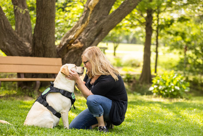 service dog with woman in the park